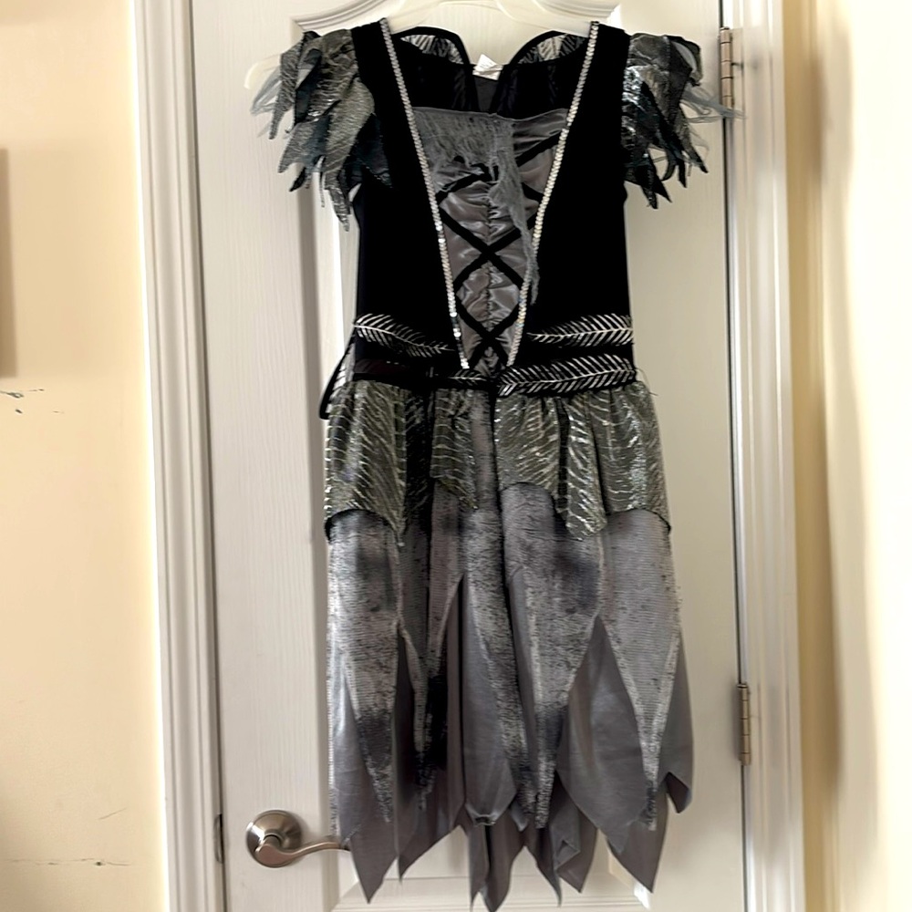 Fallen angel, has velcro wings and pull on polyester cut up pants.